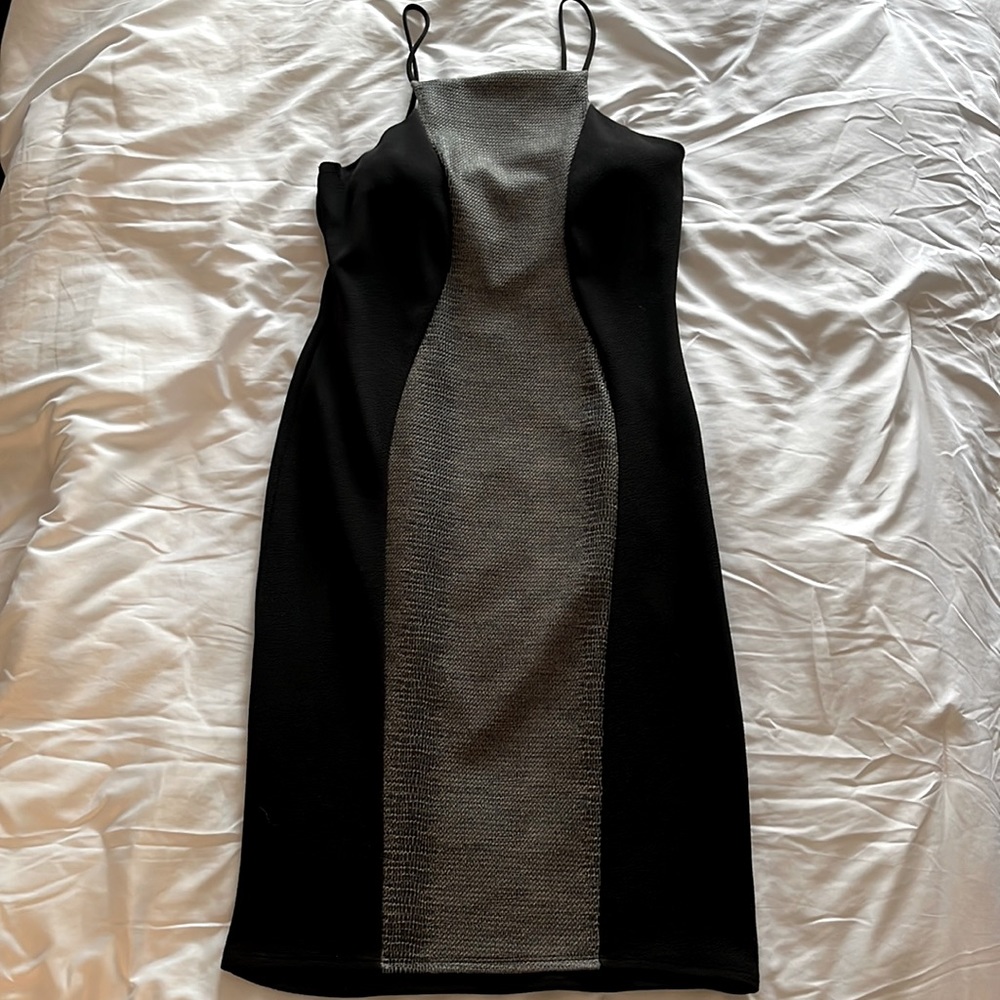 Stretchy black dress with snake pattern down the front for a sexy look.